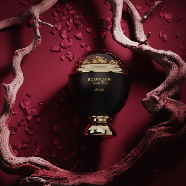Perfume bottle with 'SOUVENIR' text on a red background with decorative elements