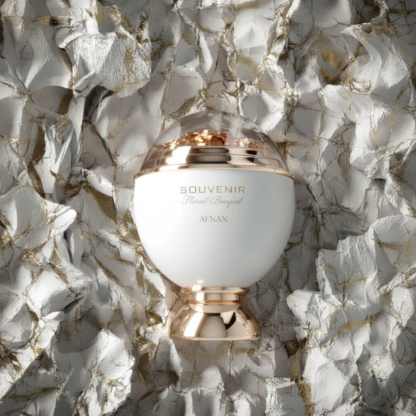 Souvenir Floral Bouquet perfume bottle with 'Souvenir' text on a textured white and gold background