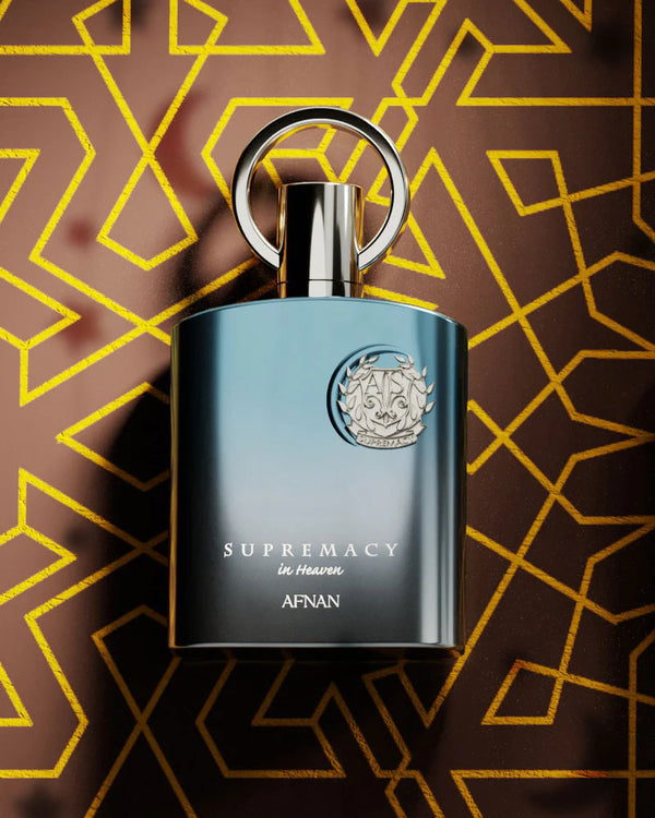 Perfume bottle labeled 'Supremacy In Heaven' by Afnan on a patterned background