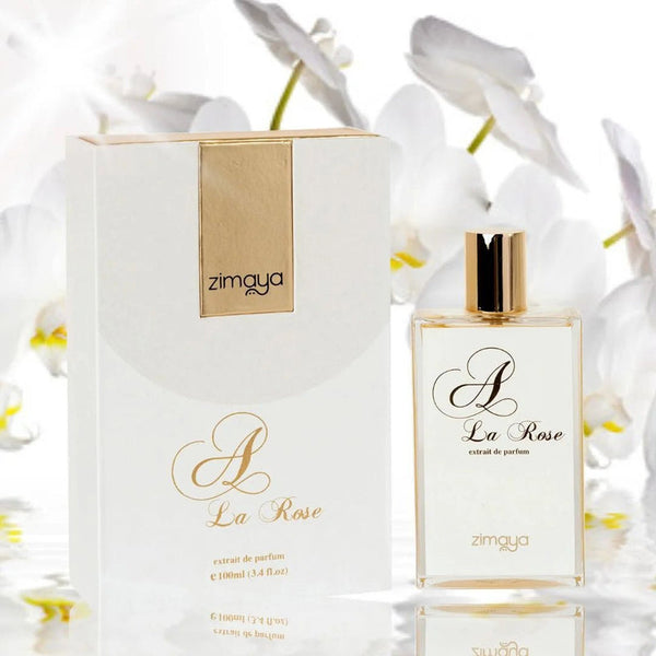 Zimaya A La Rose perfume bottle and packaging with white flowers in the background